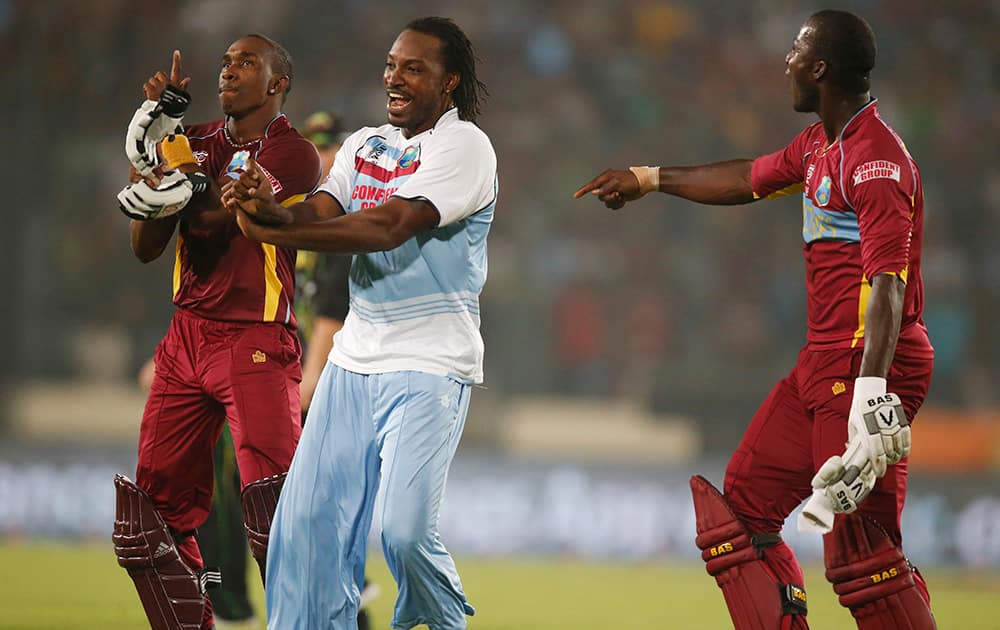 West Indies` Dwayne Bravo, Chris Gayle and captain Darren Sammy dance to celebrate their win over Australia in the ICC Twenty20 Cricket World Cup match in Dhaka, Bangladesh.