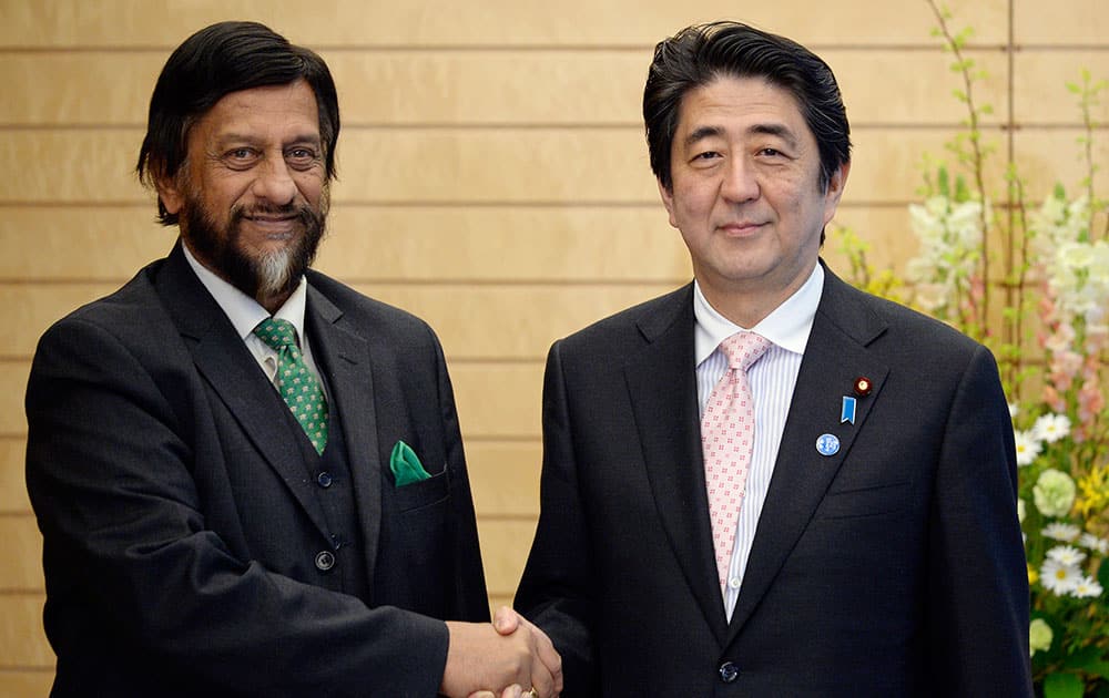Indian Nobel Peace Price laureate and Chairman of the Intergovernmental Panel on Climate Change (IPCC) Rajendra Pachauri and Japanese Prime Minister Shinzo Abe shake hands prior to their meeting at the latter`s official residence in Tokyo.