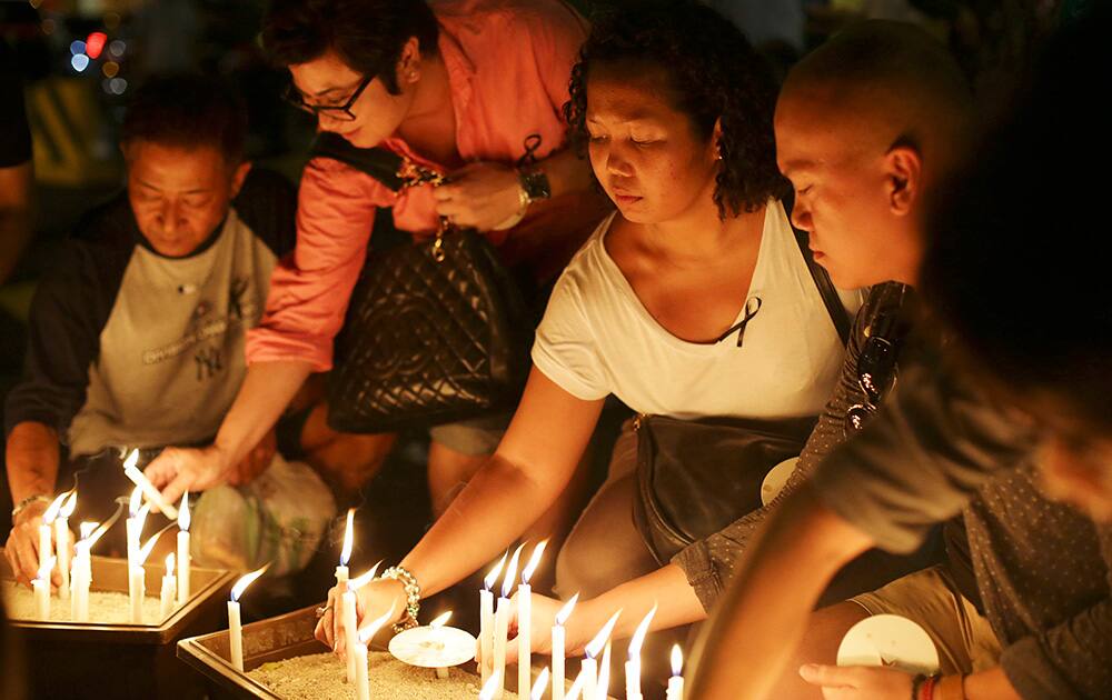 People place candles during a ceremony in memory of passengers on board the missing Malaysia Airlines Flight MH370 in Kuala Lumpur, Malaysia.