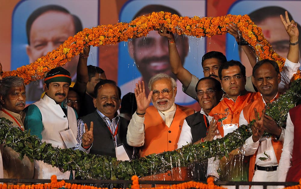 A giant floral garland is put around India`s main opposition Bharatiya Janata Party`s prime ministerial candidate Narendra Modi and other party leaders during an election rally in New Delhi.