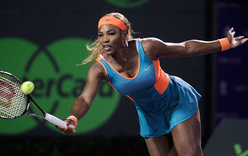 Serena Williams, of the United States, returns the ball to Angelique Kerber, of Germany, during the Sony Open tennis tournament.