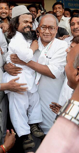 AICC General Secretary Digvijay Singh carrying 46-year old party worker Chote Saleem (3 feet height) in his lap in Bhopal.