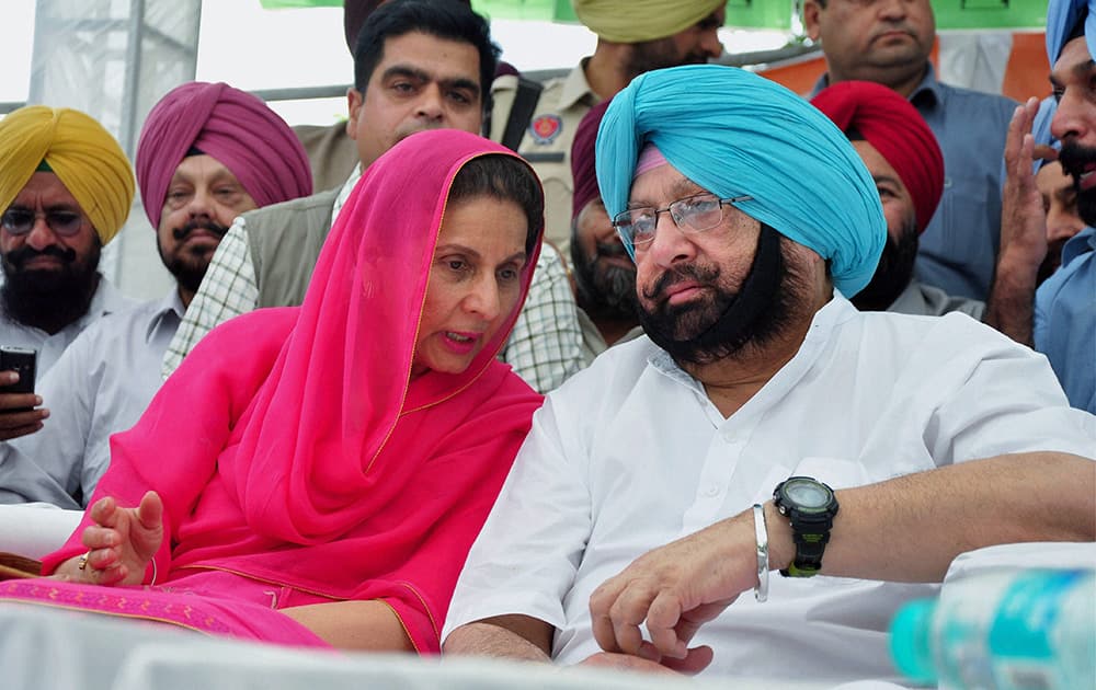 Congress leader Capt Amrinder Singh and his wife party leader Preneet Kaur at a function in Patiala.
