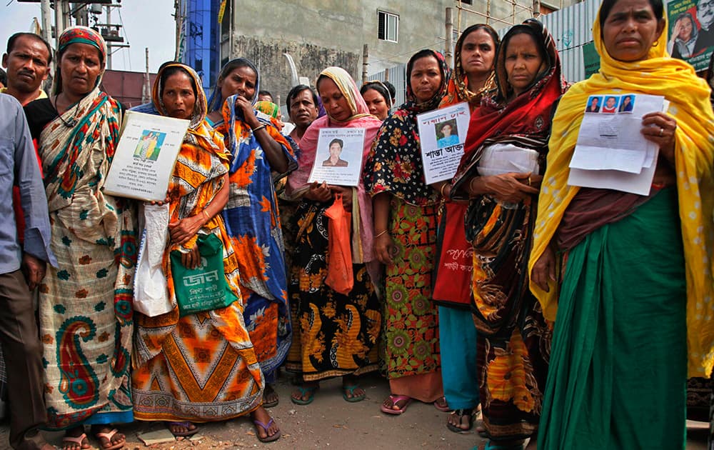 Bangladeshi relatives of the victims of the 2013 Rana Plaza factory collapse hold photographs of their dear ones during a protest in Savar, outskirts of Dhaka, Bangladesh.