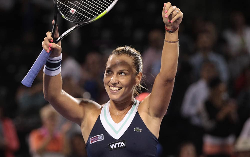 Dominika Cibulkova, of Slovakia, reacts after winning her match against Venus Williams, of the United States, during the Sony Open Tennis in Key Biscayne, Fla. She won 6-1, 5-7, 6-3