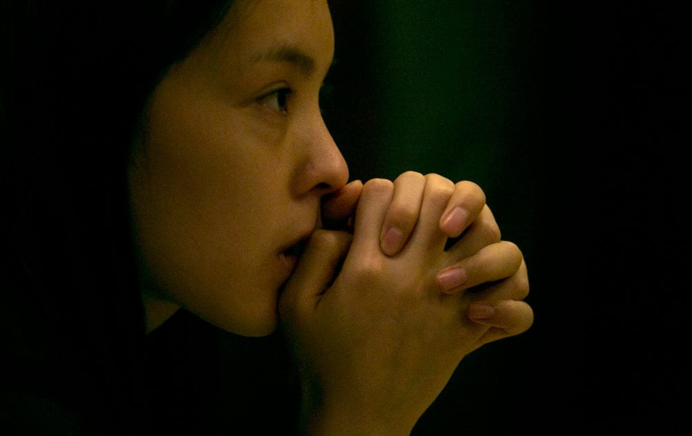 A woman waits outside a room amongst journalists waiting for relatives of the Chinese passengers onboard the missing Malaysia Airlines plane at a hotel in Beijing.