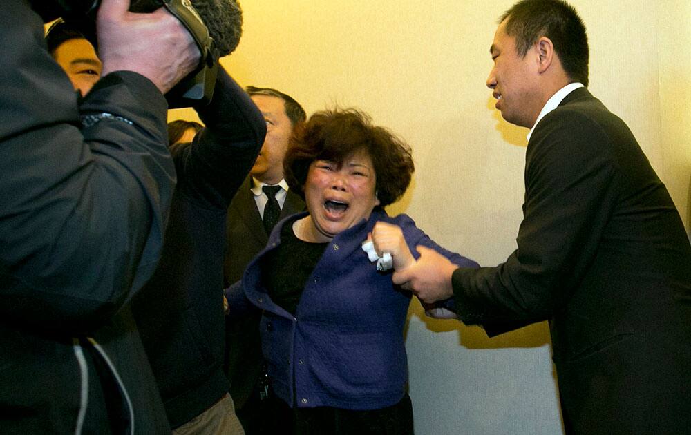 Relatives of Chinese passengers aboard the Malaysia Airlines jet, MH370, grieve after being told of the latest news in Beijing.