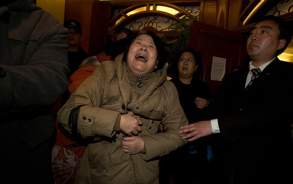 A relative of one of the Chinese passengers aboard the Malaysia Airlines jet, MH370 grieves after being told of the latest news in Beijing, China.