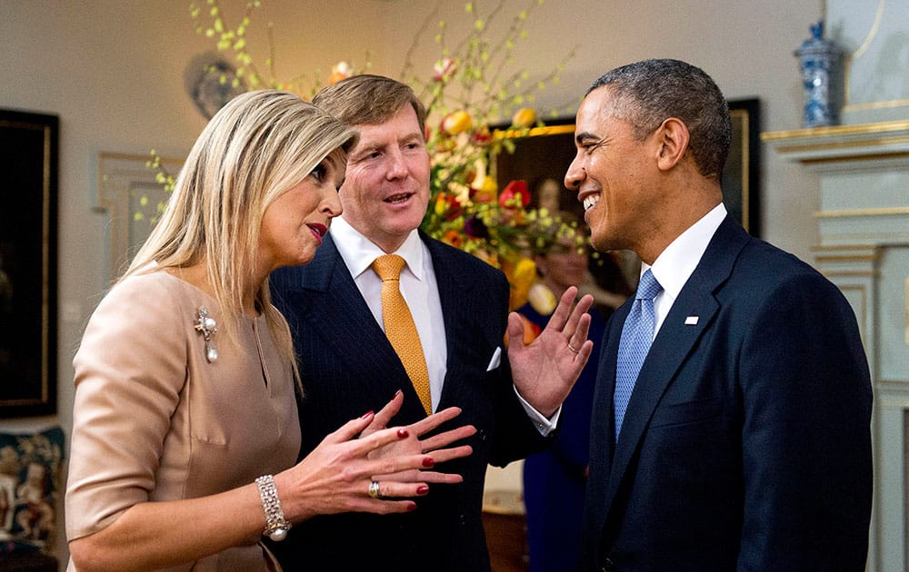Dutch Queen Maxima, left, and King Willem Alexander, center, welcome U.S. President Barack Oabama at royal palace Huis ten Bosch in The Hague, Netherlands.