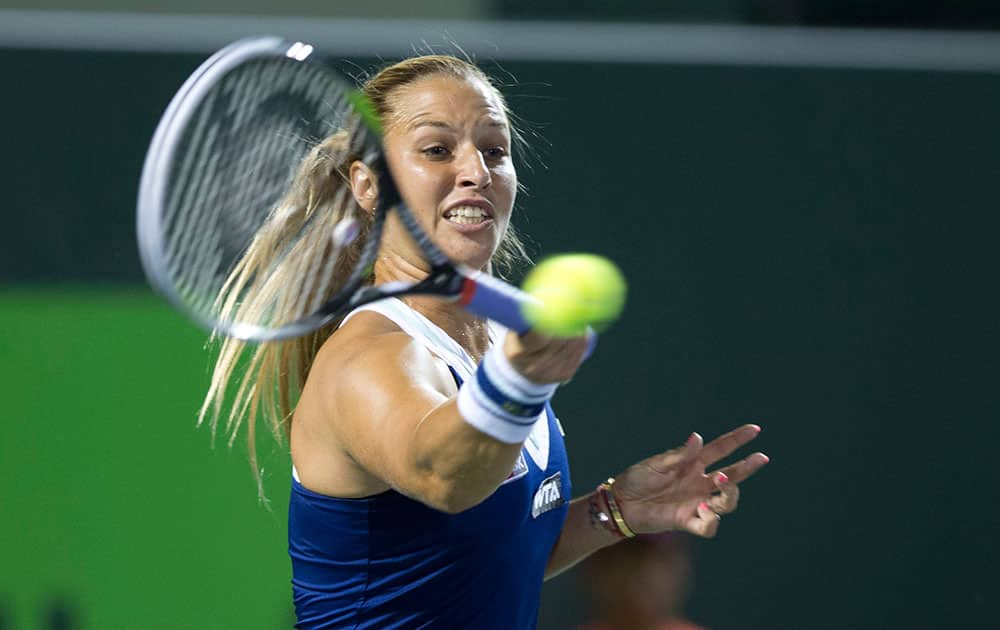 Dominika Cibulkova, of Slovakia, returns the ball to Venus Williams, of the United States, during the Sony Open Tennis in Key Biscayne, Fla.
