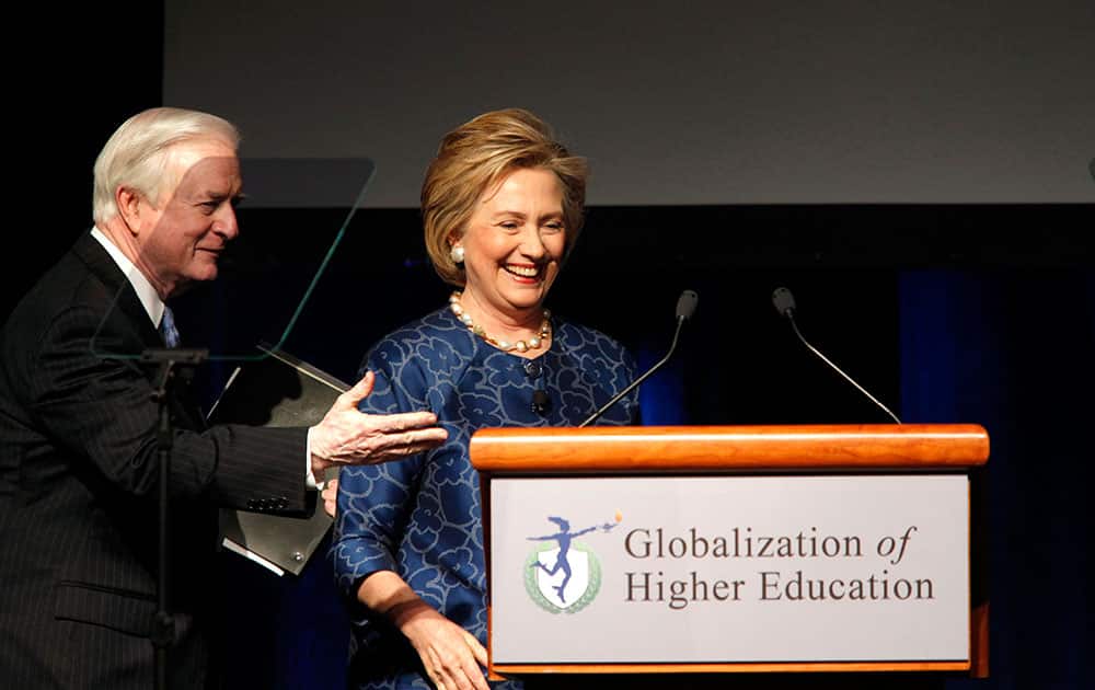 Former North Carolina Governor Jim Hunt thanks former first lady and US Secretary of State Hillary Clinton after speaking at a conference on the globalization of higher education at Four Seasons Resort and Club Las Colinas in Irving, Texas.