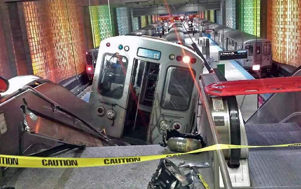 A Chicago Transit Authority train car rests on an escalator at the O`Hare Airport station after it derailed in Chicago. More than 30 people were injured after the train