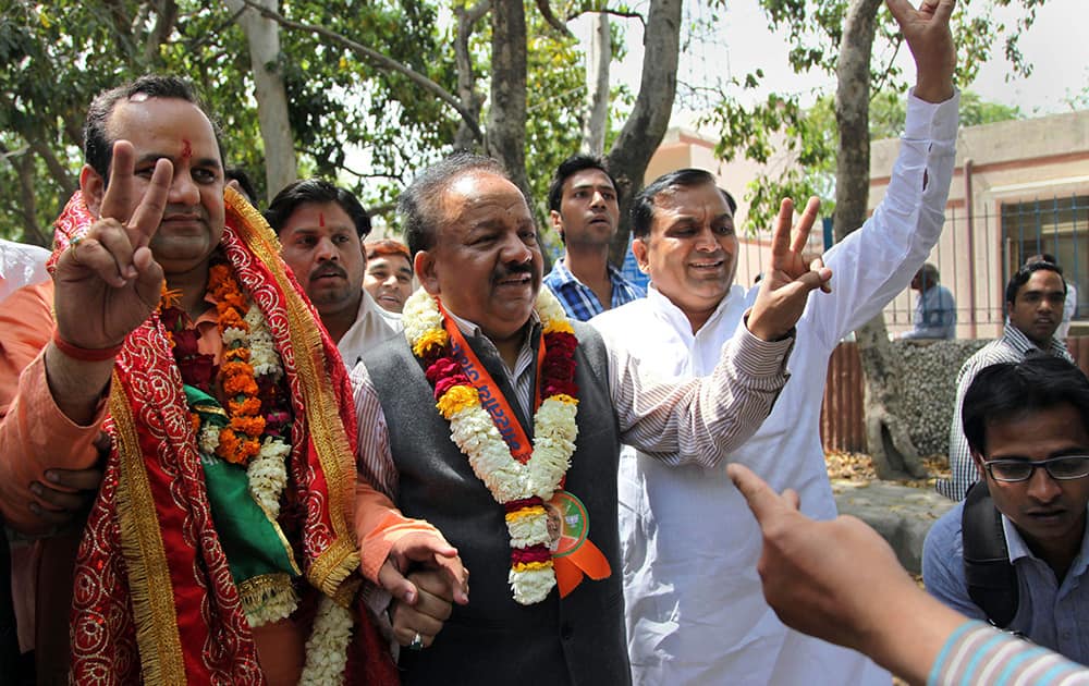 Harsh Vardhan flashes a victory sign as he arrives with party nominee Mahesh Giri to file Giri`s nomination papers for the upcoming general election in New Delhi.