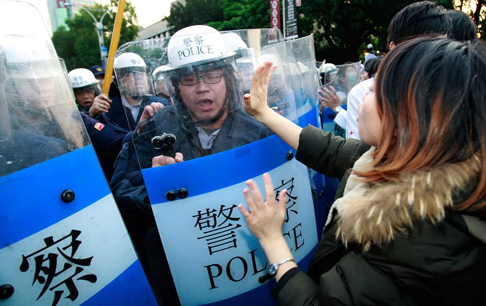 Students protesting against a China Taiwan trade pact try to stop riot police from forcibly clearing the government Cabinet buildings in Taipei, Taiwan.