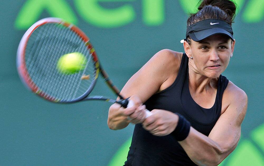 Casey Dellacqua of Australia, returns a shot from Venus Williams of the United States, at the Sony Open tennis tournament, in Key Biscayne, Fla. Williams defeated Dellacqua 6-4, 5-7, 6-4.