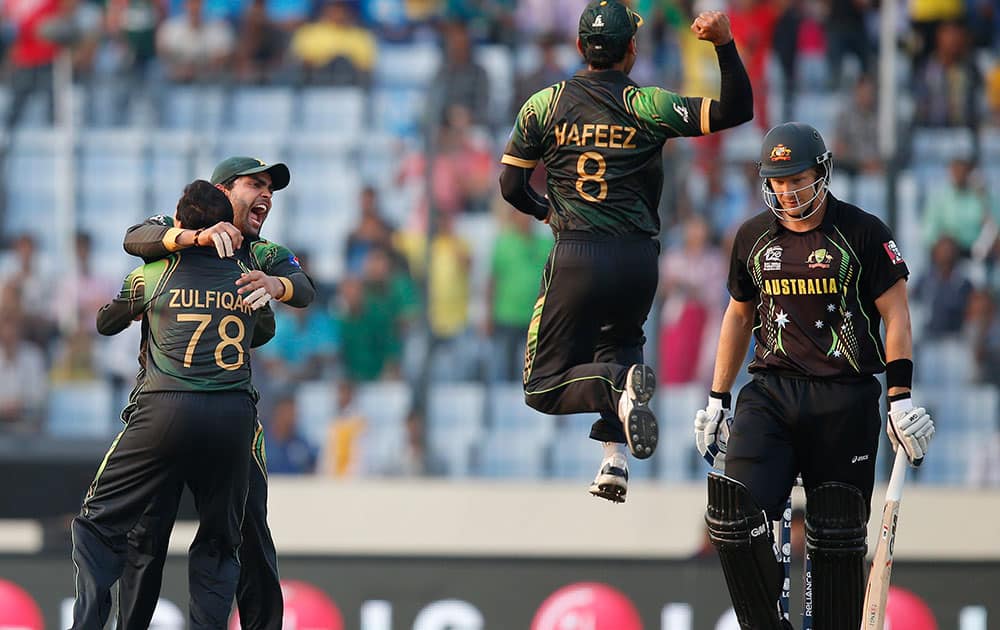 Pakistan players celebrate the dismissal of Australia`s batsman Shane Watson, right, during their ICC Twenty20 Cricket World Cup match in Dhaka, Bangladesh.