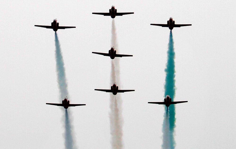 Pakistani Air Force planes fly in formation over the presidential palace during a ceremony marking National Day in Islamabad.