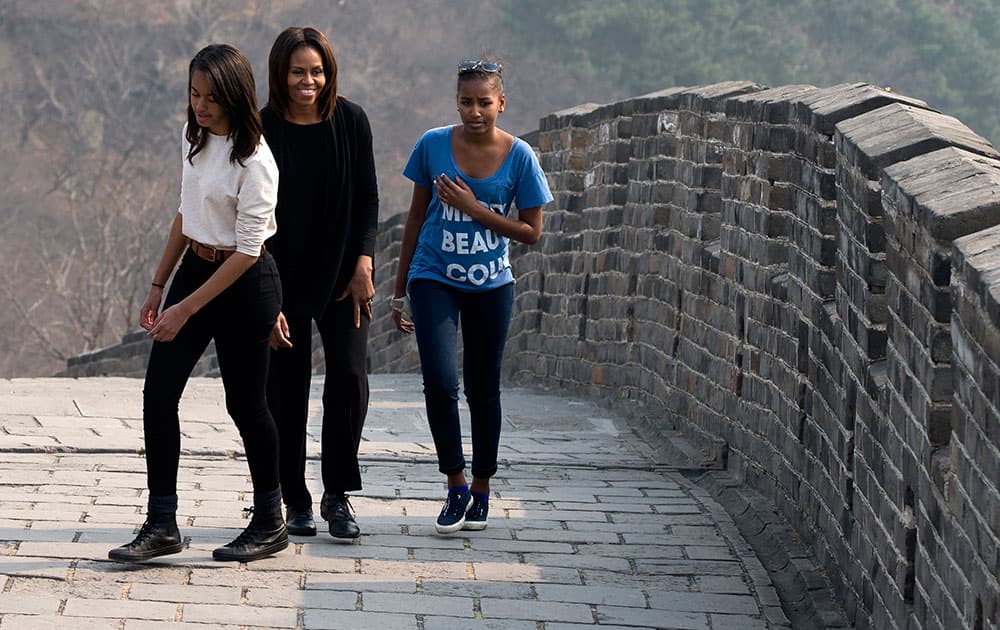 US first lady Michelle Obama walks with her daughters Malia and Sasha as they visit the Mutianyu section of the Great Wall of China in Beijing.