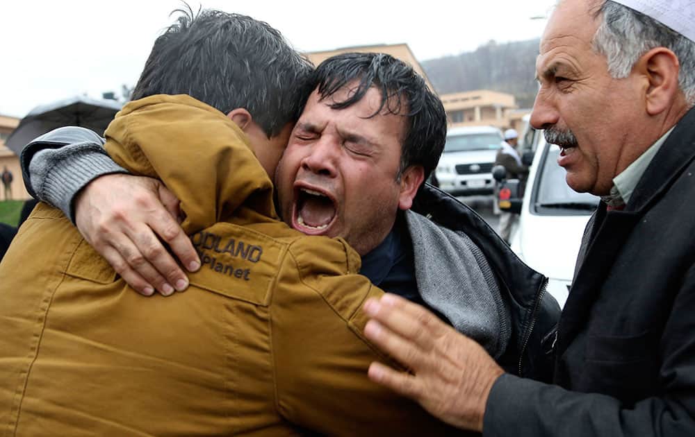 Bashir Ahmad, center, brother of killed Agence France-Press journalist Sardar Ahmad cries during his brother`s funeral ceremony in Kabul, Afghanistan. Sardar, his wife and two of his young children were killed when four gunmen attacked the Serena hotel in Kabul during New Year`s celebrations on March 20, 214. Nine people, including four foreigners were killed during the attack.