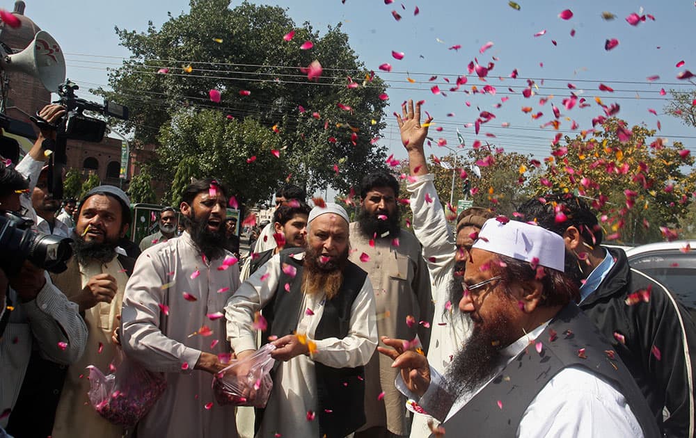 Hafiz Saeed, is greeted by supporters with flower petals, as he arrives for a press conference in Lahore.