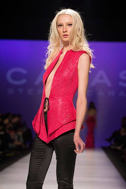A model wears a creation from Stephan Caras while walking the runway during Toronto Fashion Week in Toronto.