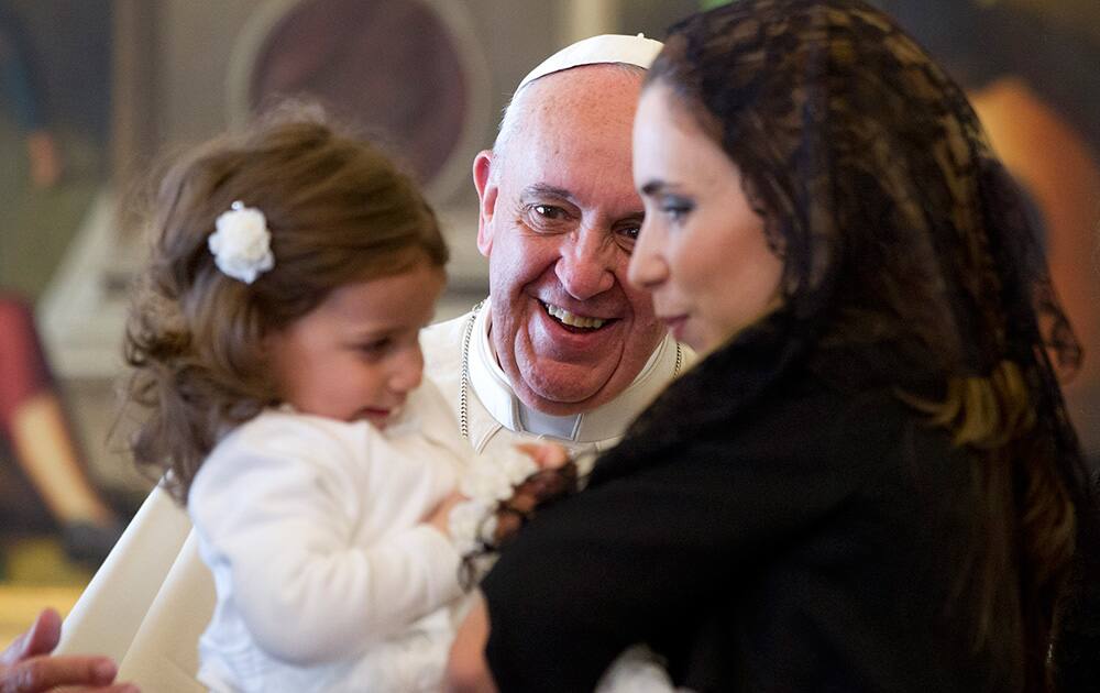 Pope Francis smiles at Giorgia May and Maria Abela, granddaughter and daughter of Malta`s President George Abela, during a private audience in the Pontiff`s studio, at the Vatican.