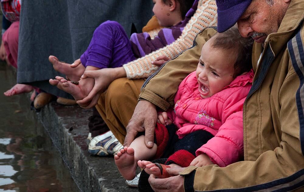 A Kashmiri boy cries after a traditional health worker uses leeches to suck blood as part of a treatment on the banks of the Dal Lake on the outskirts of Srinagar.
