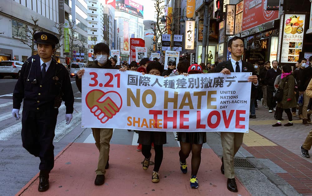 Protesters march through a shopping district in Tokyo to mark International Day for the Elimination of Racial Discrimination.