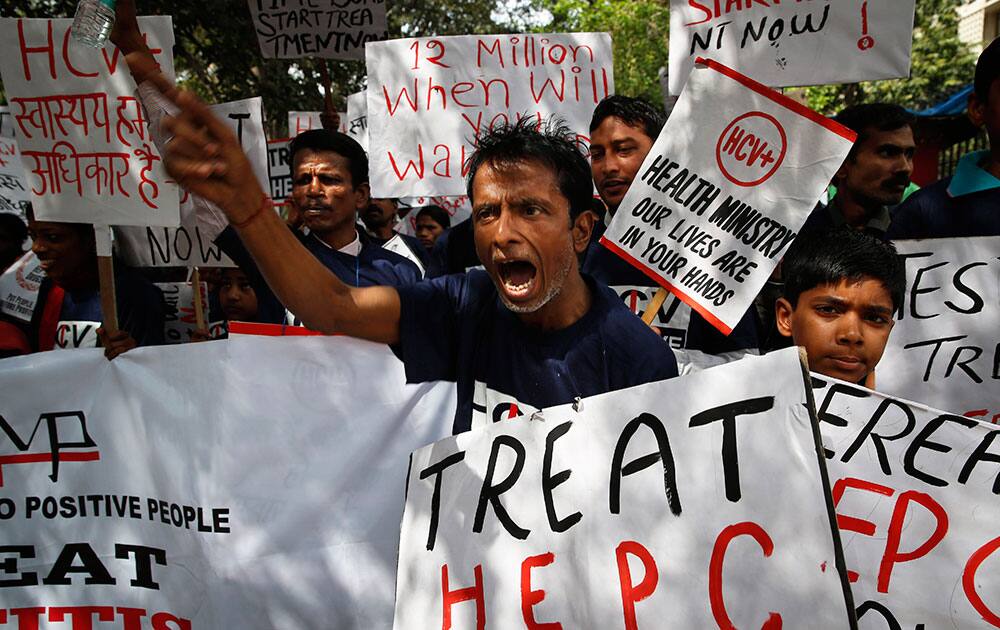 Members of Delhi Network of Positive People, a support group for HIV-positive people, shout slogans during a protest in New Delhi.
