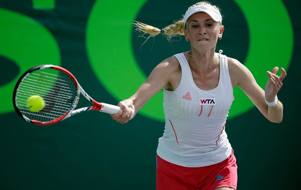 Olga Govortsova, of Belarus, returns the ball to Flavia Pennetta, of Italy, at the Sony Open tennis tournament.