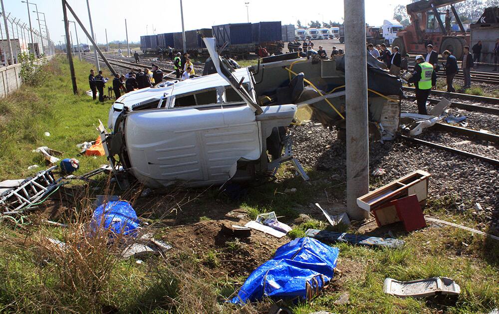 Rescue workers and onlookers are seen after a train crashed into a minibus near the Mediterranean port city of Mersin, Turkey.