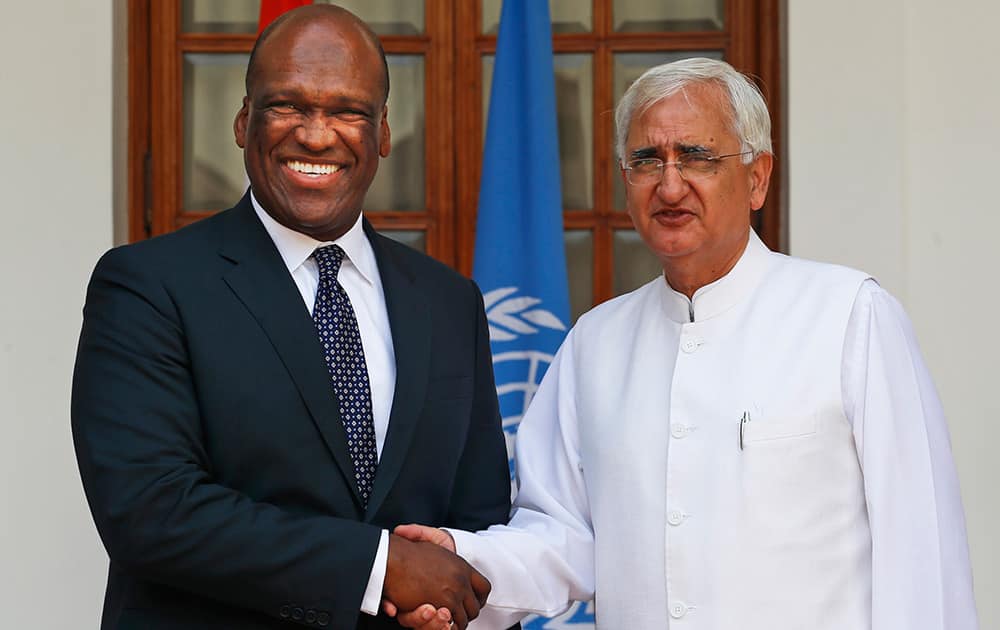 Indian Foreign Minister Salman Khurshid shakes hand with John William Ashe, President of the United Nations General Assembly at its 68th session, in New Delhi. Ashe is on a four day visit to India.