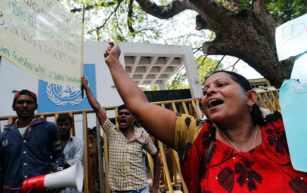 Sri Lankan government supporters from the former northern war zone area wave national flags and shout protest slogans outside the UN office in Colombo, Sri Lanka.