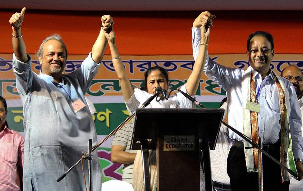 Trinamul Congress Supremo Mamata Banerjee with party candidates Soumitra Roy (North Malda) and Dr. Mouzzen Hossen(South Malda) during an election campaign rally in Malda.