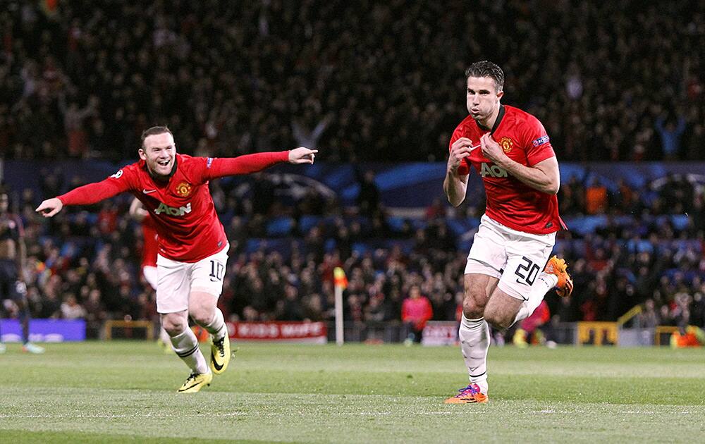 Manchester United`s Robin van Persie celebrates scoring their third goal, and his hat-trick against Olympiakos, with team-mate Wayne Rooney during the UEFA Champions League, Round of 16, second leg match at Old Trafford, Manchester, England.