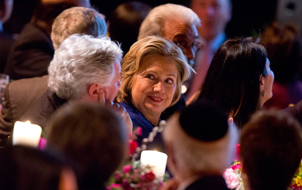 Former Secretary of State Hillary Rodham Clinton talks with other guests before receiving the American Jewish Congress` lifetime achievement award in New York.