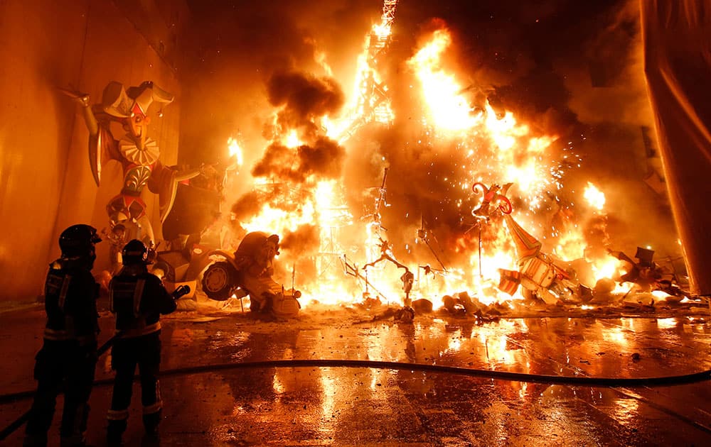 Satirical sculptures burn during the traditional Fallas festival in Valencia, Spain. Every year the city of Valencia celebrates the ancient
