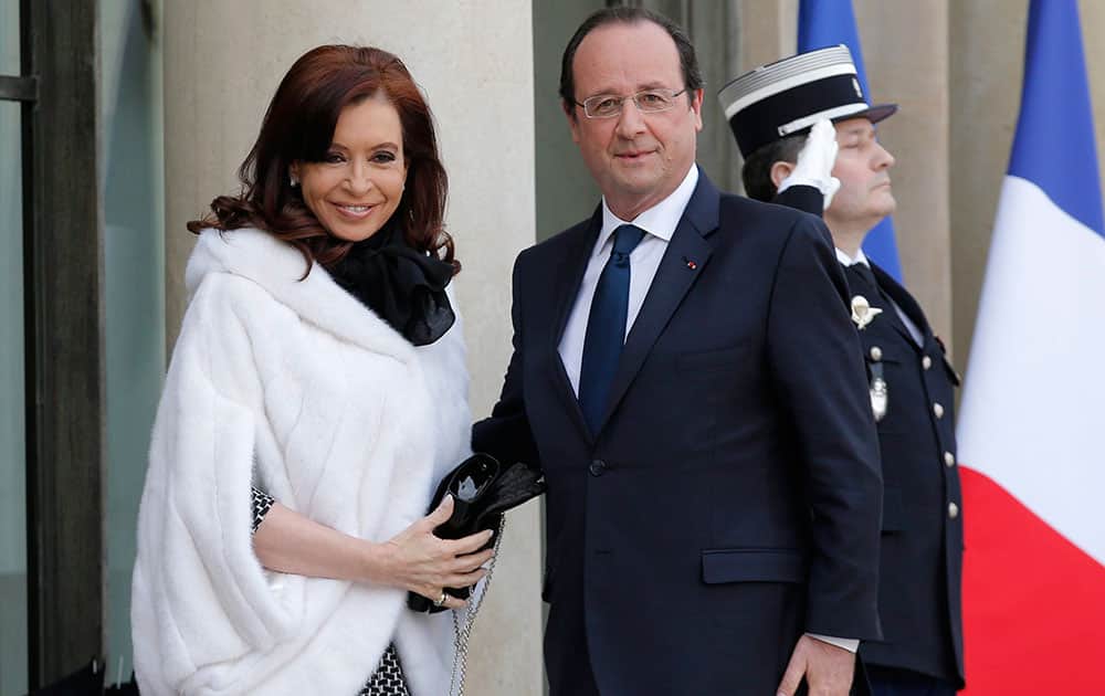 French President Francois Hollande, right, greets Argentine President Cristina Fernandez at the Elysee Palace in Paris.