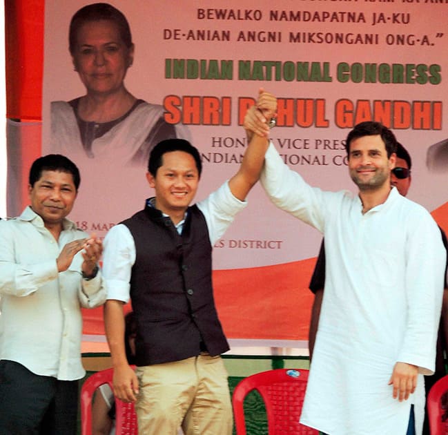 Congress Vice President Rahul Gandhi raises his hand with party candidate Daryl William Momin at an election rally at Resubelpara in North Garo Hills. Meghalaya Chief Minister Mukul Sangma is also seen.