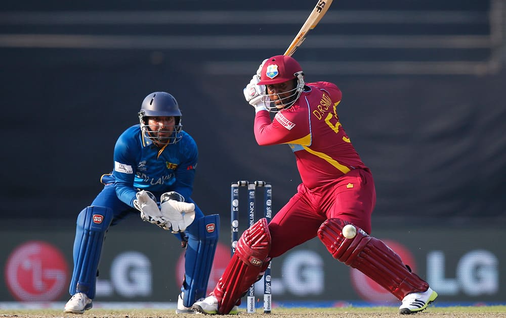 West Indies` batsman Dwayne Smith prepares to play a shot as Sri Lanka`s wicketkeeper Kumar Sangakkara takes his position during their ICC Twenty20 Cricket World Cup warm up match in Dhaka, Bangladesh.