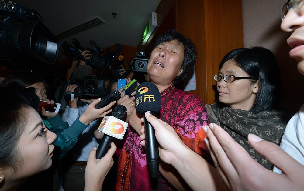 A Chinese relative of passengers aboard a missing Malaysia Airlines plane cries as she speaks to journalists at a hotel in Sepang, Malaysia.