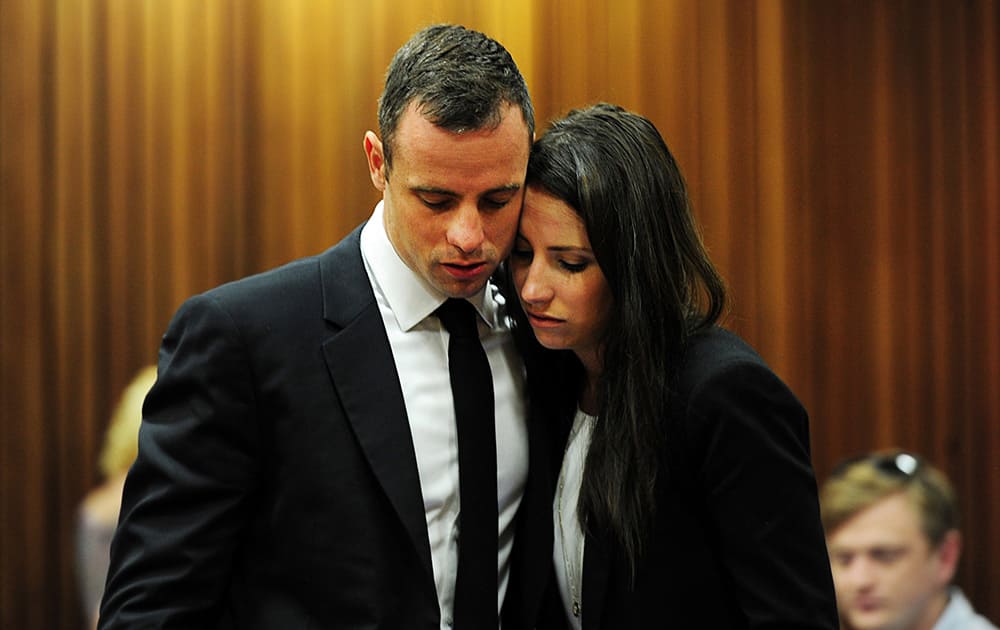 Oscar Pistorius hugs his sister Aimee in court in Pretoria, South Africa. Pistorius is on trial for the murder of his girlfriend Reeva Steenkamp on Valentine`s Day in 2013.