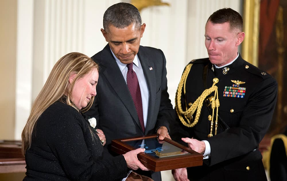 Shyrell Jean Copas, left, accepts the Medal of Honor on behalf her father Spc. Ardie R. Copas, from President Barack Obama, during a ceremony in the East Room of the White House.