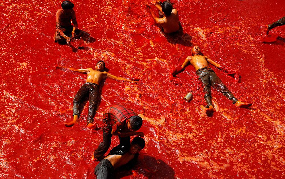 Children play in a pool of colored water at the end of Holi celebrations, the Hindu festival of colors, at the Baldev Temple in Dauji, 180 kilometers (113 miles) south of New Delhi.
