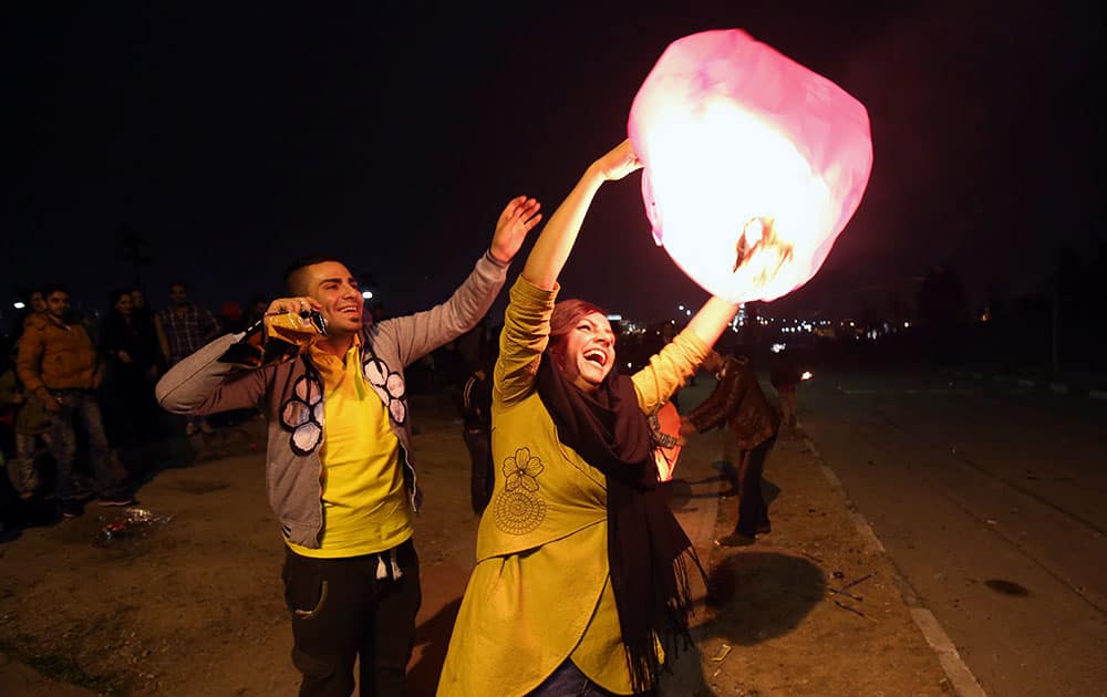 Two Iranians fly a wishing lantern in the Pardisan Park in Tehran, Iran, during Chaharshanbe Souri, or Wednesday Feast, an ancient Festival of Fire, on the eve of the last Wednesday of the year, when Iranians jump over burning bonfires and throw firecrackers celebrating arrival of the spring which coincides with their new year, or Nowruz, which begins on March 21.