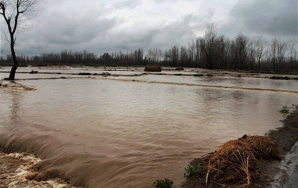 Rain and snowfall in Jammu and Kashmir inundates agriculture land in south Kashmir’s Koil area of Pulwama.