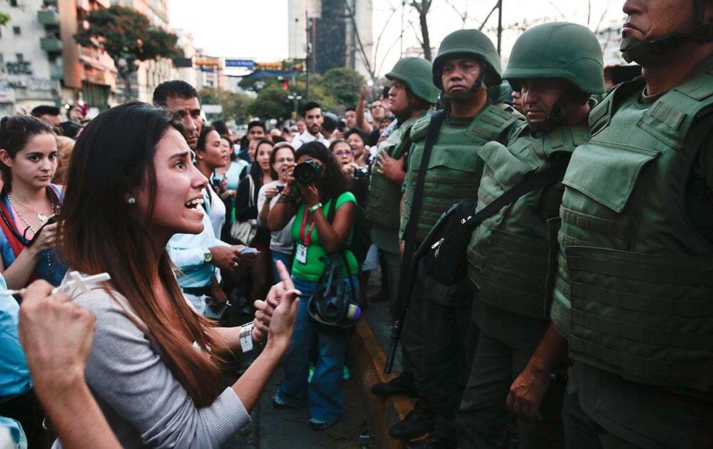 An anti-government protester argues with Bolivarian National Guards in Plaza Altamira in Caracas, Venezuela.