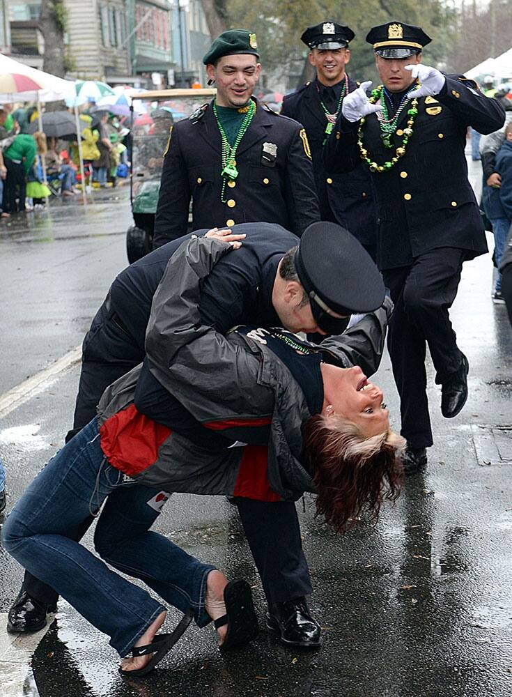 Los Angeles Police Department`s Jim Mcsorley dips Tina Shamlian in the middle of East Broad Street as he marches with fellow police officers during Savannah`s 190-year-old St. Patrick’s Day parade.