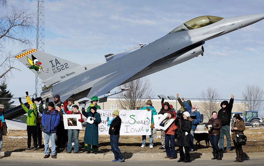 Protesters rally outside the Iowa Air National Guard base, in Des Moines, Iowa. Seven protesters, who were rallying against the use of drones to carry out military strikes, were arrested at the base.