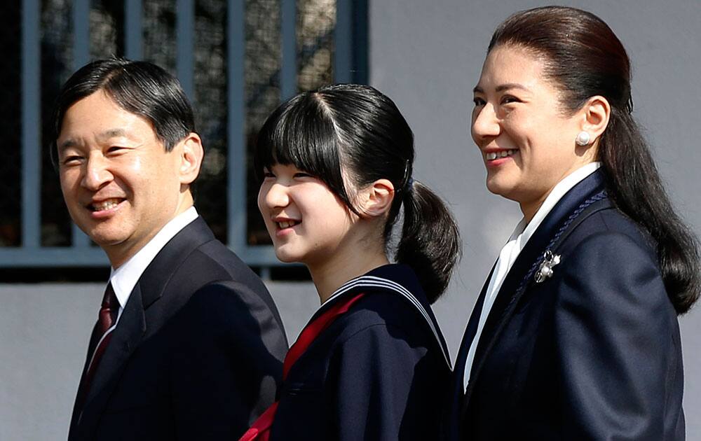 Japan`s Princess Aiko, accompanied by her parents Crown Prince Naruhito and Crown Princess Masako, arrives to attend her graduation ceremony at the Gakushuin Primary School in Tokyo.